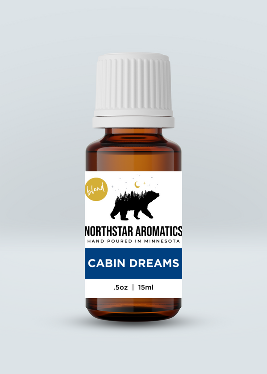 Cabin Dreams Blend essential oil bottle by Northstar Aromatics with woodsy, pine scent for home and office spaces.