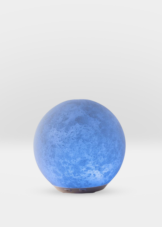 Moonglow Diffuser with rotating blue light and sleek modern design for aromatherapy and home decor.
