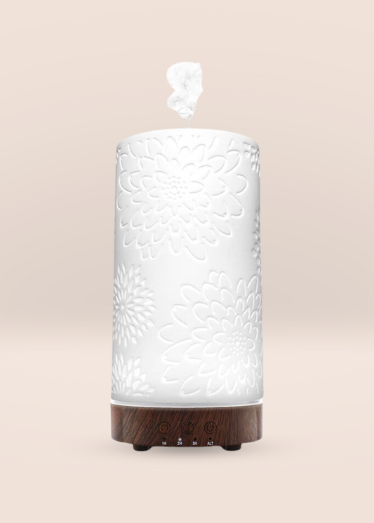 Joy Diffuser handcrafted with white flower bursts, kaolin clay, and timer settings for aromatherapy ambiance.