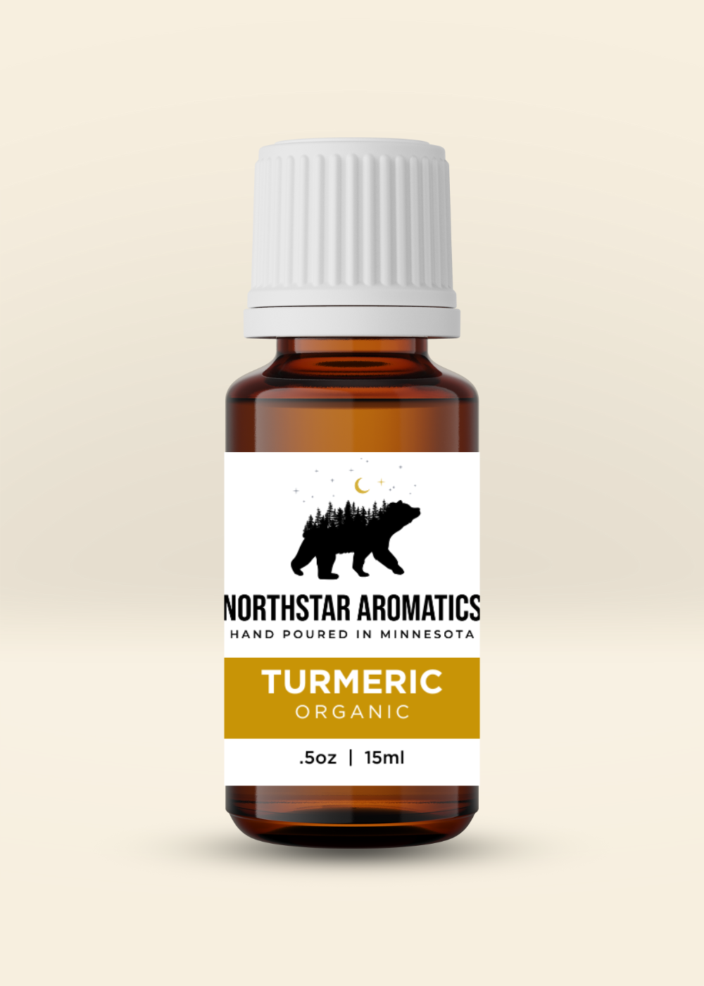 Amber glass bottle of organic turmeric essential oil with white cap and Northstar Aromatics label on beige background