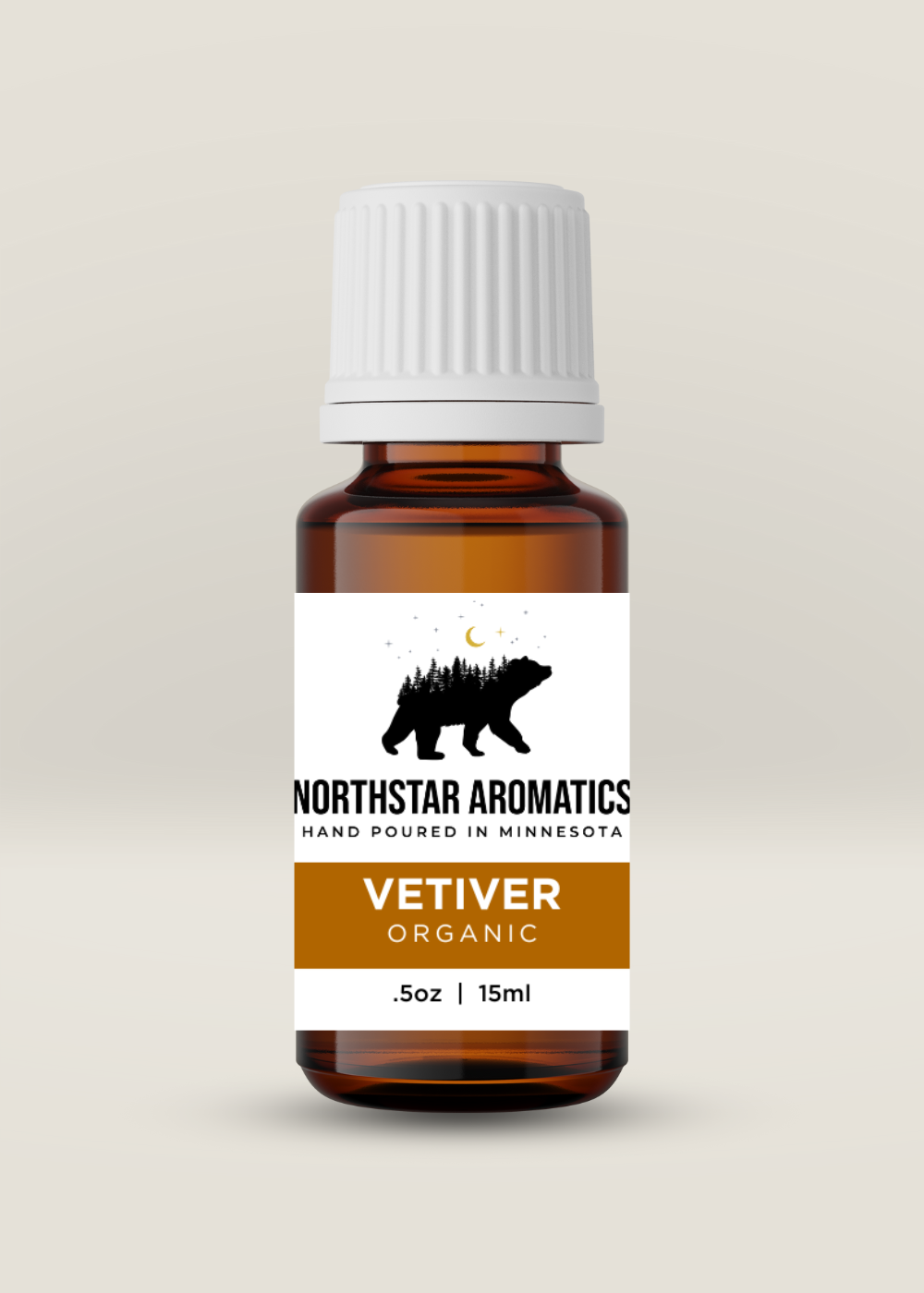 Amber glass bottle of Vetiver essential oil with white cap and Northstar Aromatics label on neutral background
