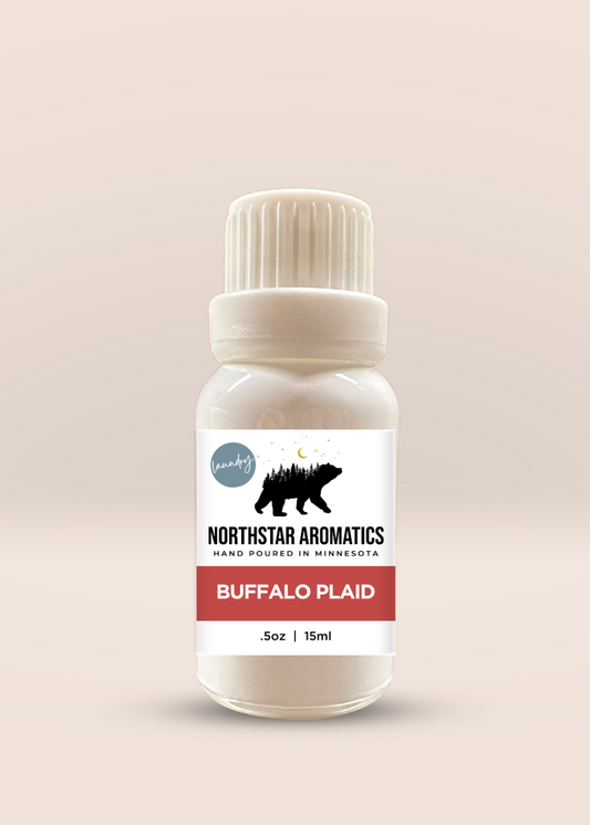 Bottle of Buffalo Plaid Laundry Oil by Northstar Aromatics with a minimalist label and white cap.