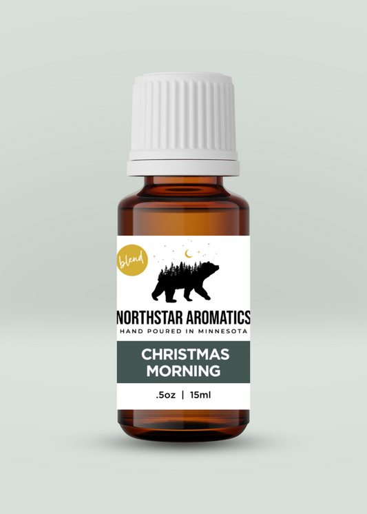 Christmas Morning Blend 15ml essential oil bottle from Northstar Aromatics with pine tree and bear design label.