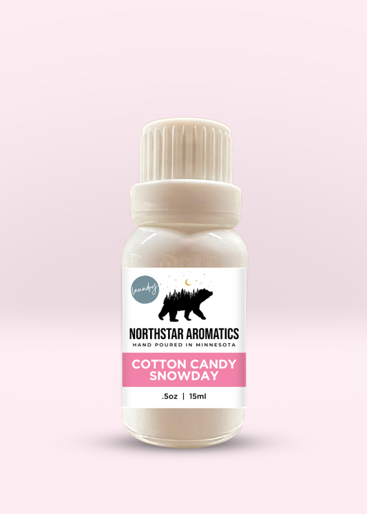 Cotton Candy Snowday laundry oil by Northstar Aromatics with sweet plum and berry scent, 15ml bottle on pink background.