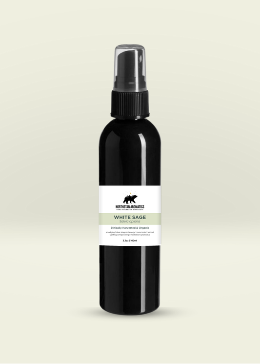 Black spray bottle with a white and green label on a light beige background