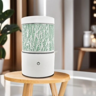 Minimalist white ultrasonic diffuser with delicate willow branch pattern and soft ambient light on round base