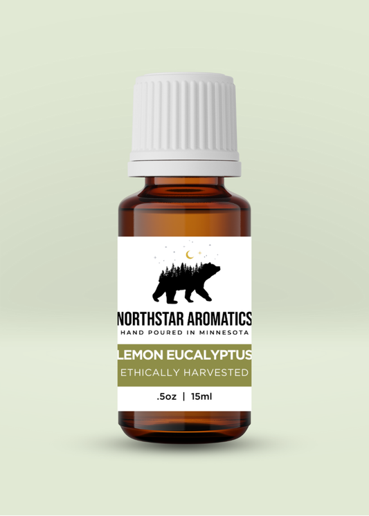 Amber glass bottle of ethically harvested Lemon Eucalyptus essential oil by Northstar Aromatics with white cap on pale green background