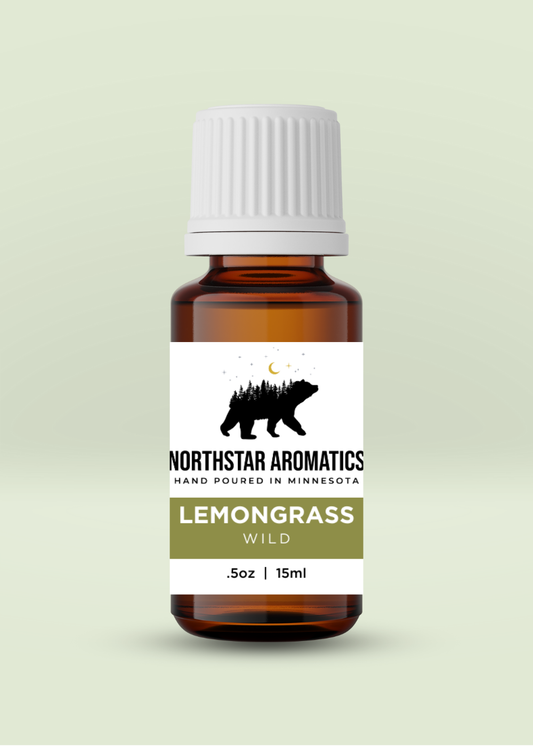 Amber glass bottle of wild Lemongrass essential oil by Northstar Aromatics with white cap on pale green background