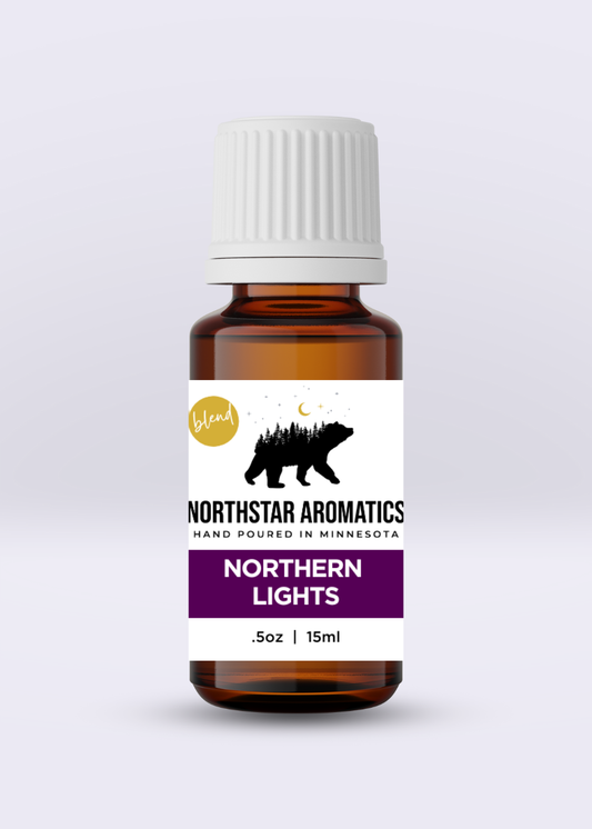 Amber glass bottle of Northern Lights blend essential oil with white cap and forest bear label design