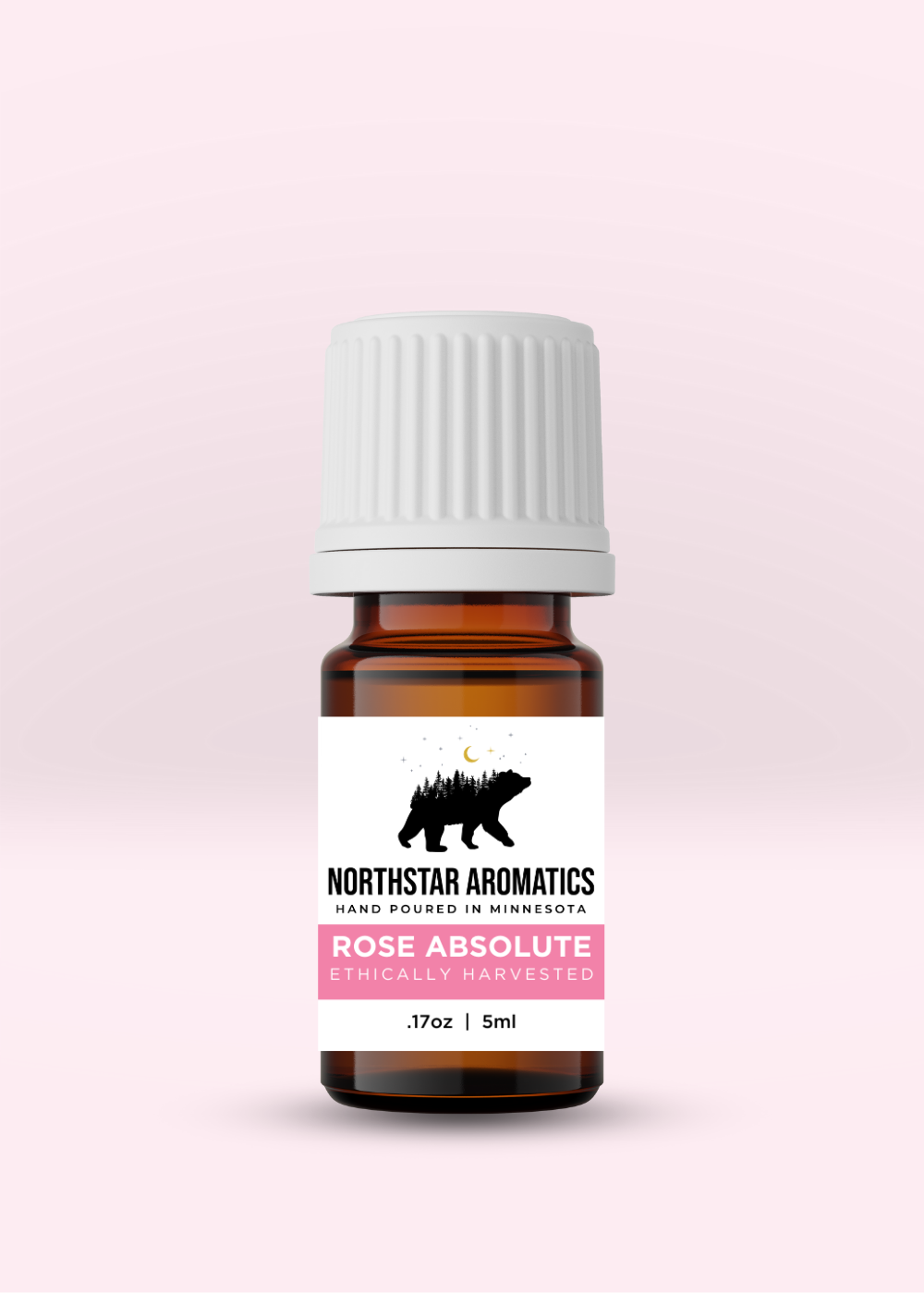 Rose Absolute aromatic oil bottle by Northstar Aromatics with amber liquid in a 5ml container on pink background