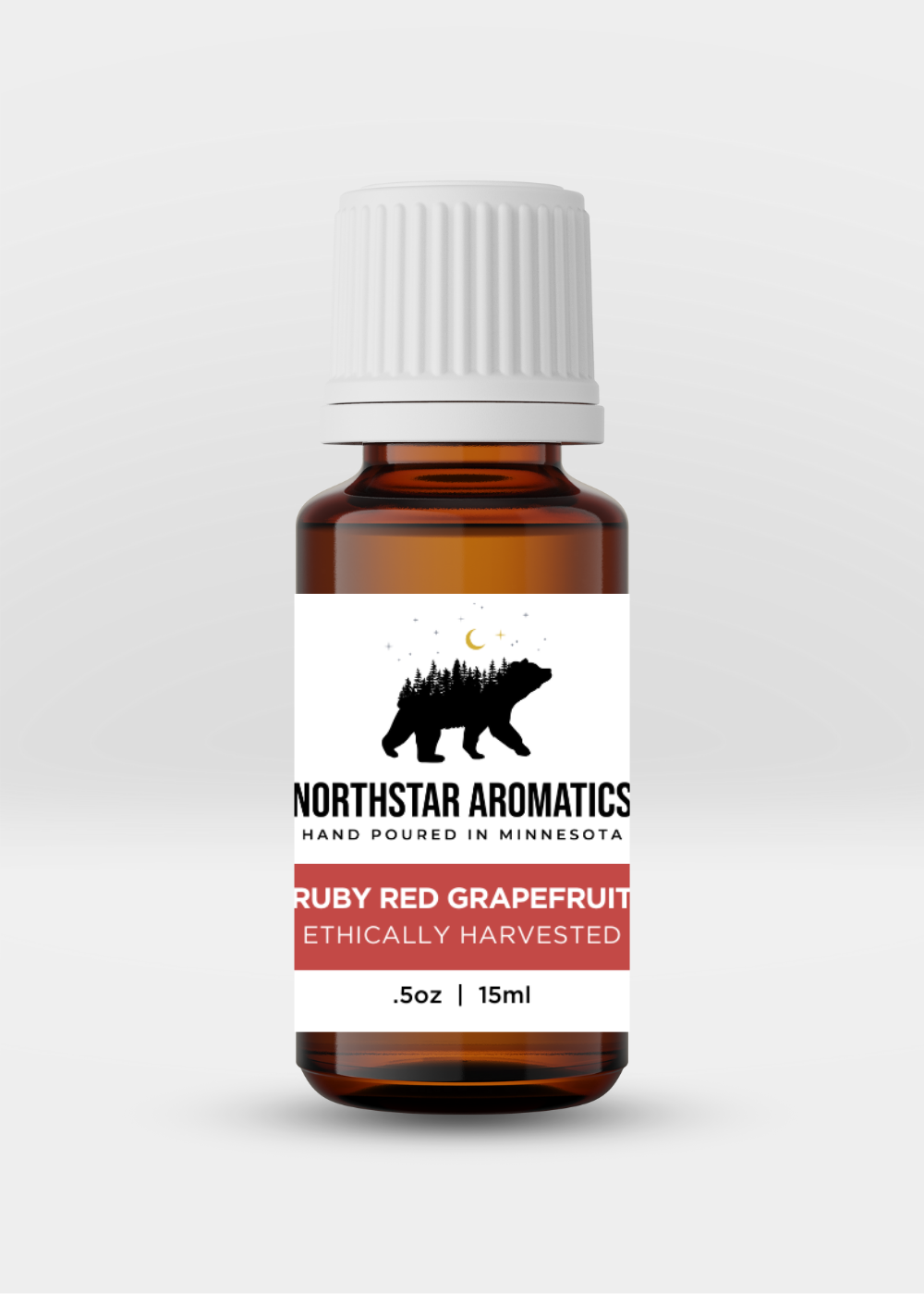 Amber glass bottle of Ruby Red Grapefruit essential oil by Northstar Aromatics, 15ml with white cap.