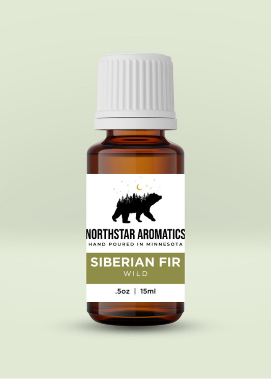 Amber glass bottle of Siberian Fir essential oil by Northstar Aromatics with white cap on pale green background