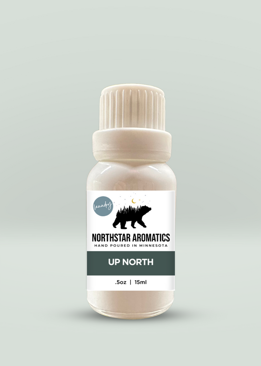 Up North Laundry Oil 15ml bottle with bergamot, pear, clove, tobacco, and winter rose scent notes.