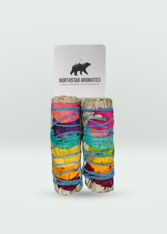 Chakra White Sage Smudge bundle wrapped in rainbow petals for energetic healing and purification by Northstar Aromatics.