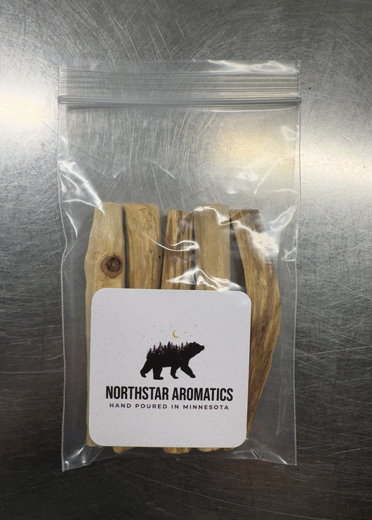 Clear resealable bag containing Palo Santo Smudge Sticks with Northstar Aromatics branding label visible.