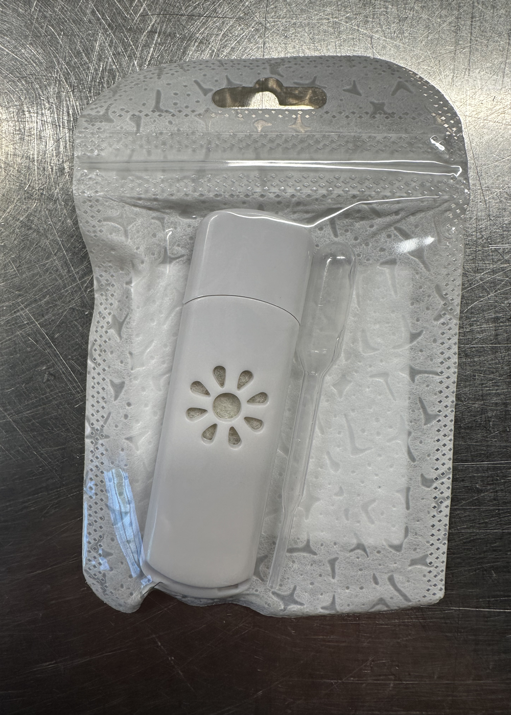 USB Aromatherapy Diffuser in sealed packaging with a small plastic dropper for essential oils, ideal for USB-powered use.