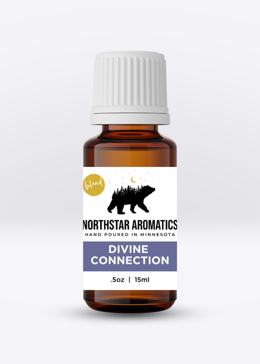 Amber glass bottle of Divine Connection essential oil blend by Northstar Aromatics with white cap and label design